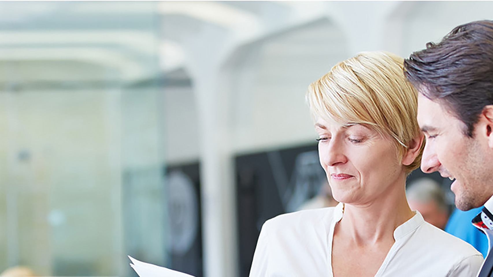 Two person discuss a document