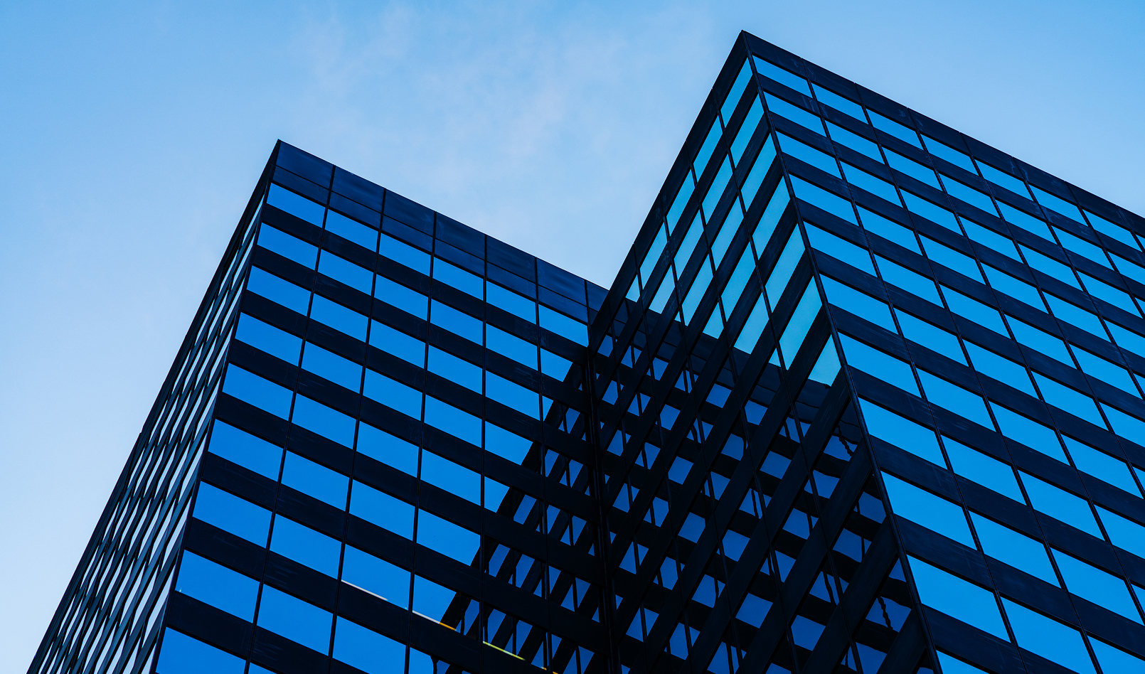 A shiny skyscraper below a blue sky