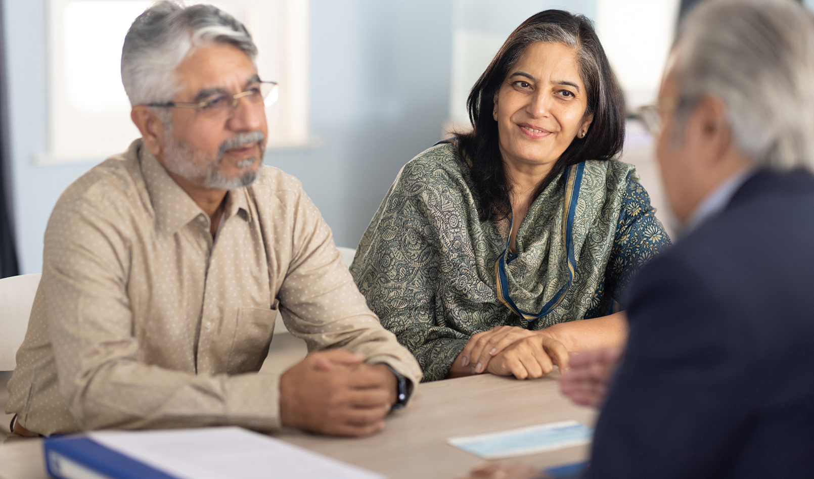 A married couple meeting with a personal banking planner