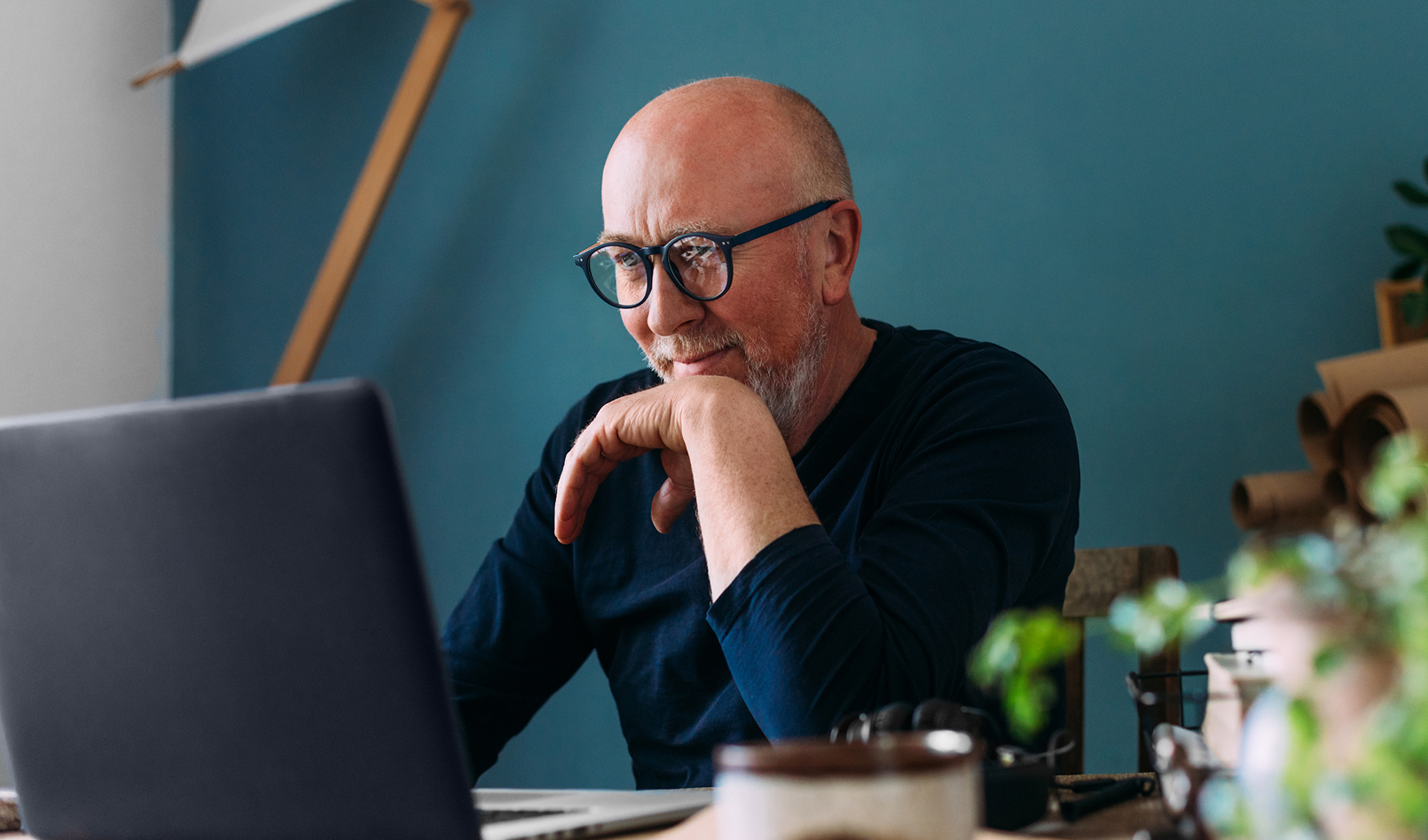 A man completing personal banking transactions on a laptop