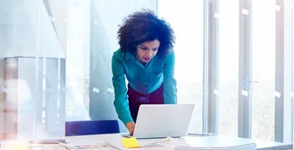 Woman working in modern glass office
