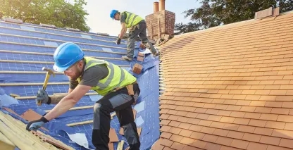 Professional roofers working on a residential building