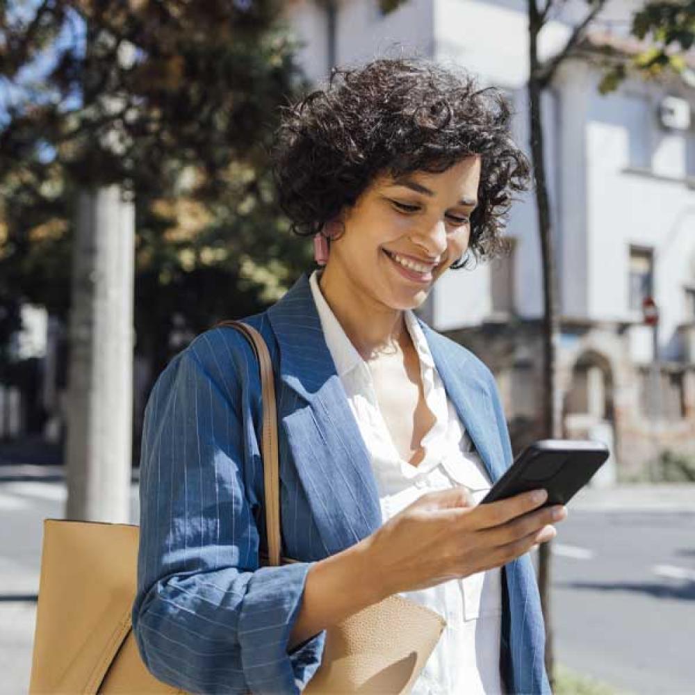 A woman opening a high-yield savings account on her mobile phone