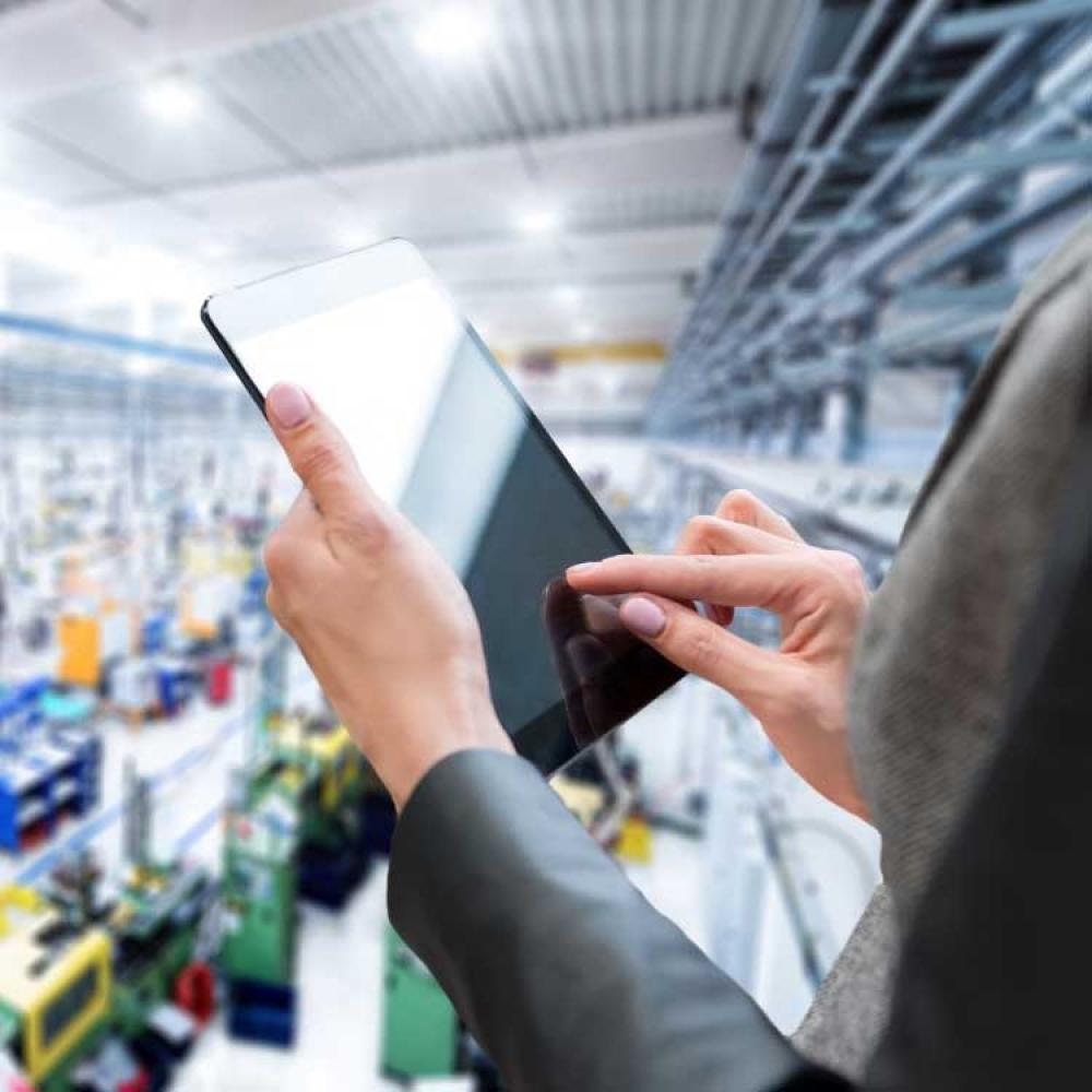 A person taking warehouse inventory on a tablet