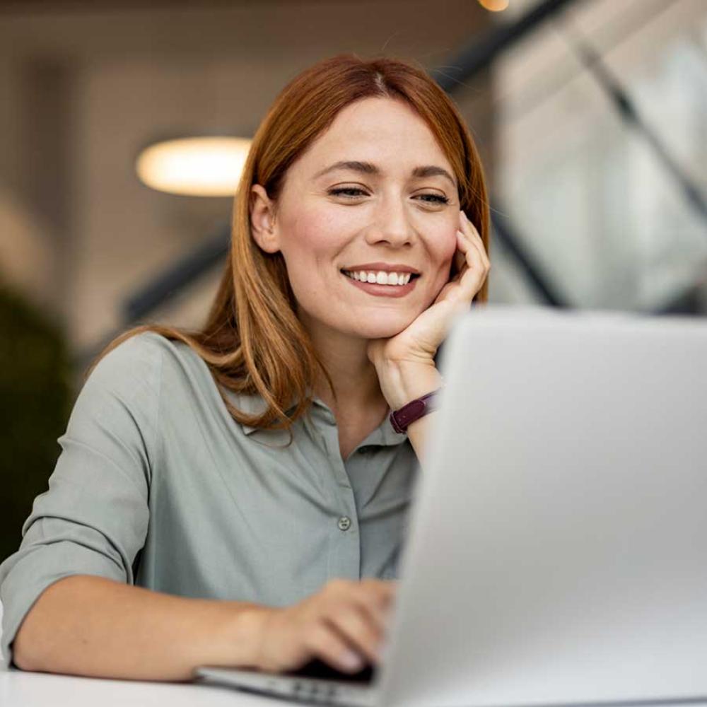 A businesswoman completing banking transactions on her laptop