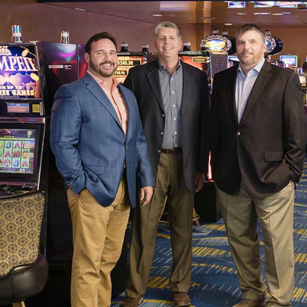 Three businessmen standing in a casino